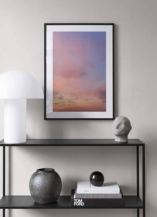  – Foto van een zonsondergang met roze wolken tegen een lichtpaarse hemel